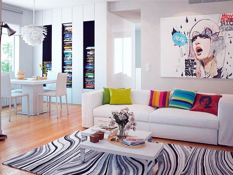 обустройство жилой комнаты картиной и разноцветным текстилем